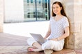 Portrait of a happy young woman using laptop computer outdoors Royalty Free Stock Photo