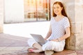 Portrait of a happy young woman using laptop computer outdoors Royalty Free Stock Photo