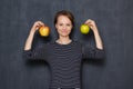 Portrait of happy young woman smiling and holding apples in hands Royalty Free Stock Photo