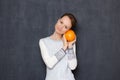 Portrait of happy young woman smiling and holding grapefruit in hands Royalty Free Stock Photo