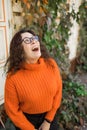 Portrait of happy young woman smiling with urban background. Cheerful latin girl wearing eyeglasses in the city. Happy Royalty Free Stock Photo