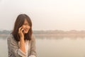 Portrait happy young woman smiling and walking in the street using talking on smartphone and looking at camera Royalty Free Stock Photo