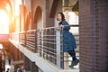 Portrait of a happy young woman standing in the hall at sunset Royalty Free Stock Photo