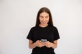Portrait of happy young woman texting message on mobile phone Royalty Free Stock Photo