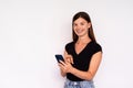 Portrait of happy young woman texting message on mobile phone Royalty Free Stock Photo