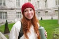 Portrait of happy young woman, tourist with backpack sightseeing, drinking hot tea from thermos, holding flask and Royalty Free Stock Photo