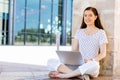 Portrait of a happy young woman using laptop computer outdoors Royalty Free Stock Photo