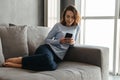 Portrait of a happy young woman using mobile phone