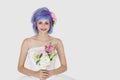 Portrait of happy young woman in wedding dress with dyed hair against gray background Royalty Free Stock Photo