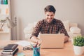 Portrait of happy young writer typing new book on laptop