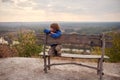 Portrait of happy young boy sitting on a wooden bench outdoors Royalty Free Stock Photo