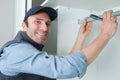 portrait hapy man during fitted kitchen cabinet installation