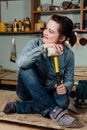 Portrait hardworking middle aged adult professional female carpenter worker workshop or garage.