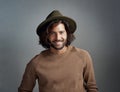 Portrait, hat and smile of man in studio isolated on a gray background. Face, fedora and handsome male person or model Royalty Free Stock Photo