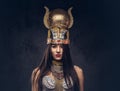 Portrait of haughty Egyptian queen in an ancient pharaoh costume. Royalty Free Stock Photo