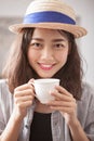 portrait head shot of beautiful younger asian woman and hot coffee cup in hand happiness emotion Royalty Free Stock Photo