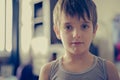 Portrait head shot of sad young boy child looking at camera Royalty Free Stock Photo