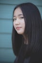 Portrait headshot of asian teenager looking with eyes contact to camera