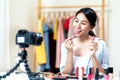 Portrait or headshot of attractive young asian influencer, beauty blogger, content creator or vlogger girl review make up looking Royalty Free Stock Photo