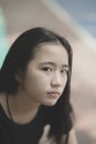 Portrait headshot of beautiful asian teenager looking with eyes contact outdoor