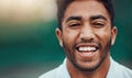Portrait headshot of smiling indian tennis player on court with copyspace. Happy fit ethnic sports professional standing Royalty Free Stock Photo