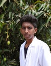 Portrait of a health worker. Picture of a young male doctor wearing a lab coat and standing outside Royalty Free Stock Photo