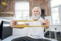 Senior man using rubber band for training arms Royalty Free Stock Photo