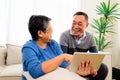 Portrait of healthy senior man and woman using laptop together on sofa at home, Happy senior married couple spending Royalty Free Stock Photo