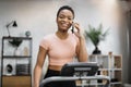 Young african american female in pink t-shirt jogging on treadmill Royalty Free Stock Photo