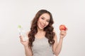 Portrait of a healthy woman with apple and bottle of water. Healthy fitness and eating lifestyle concept Royalty Free Stock Photo