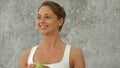 Portrait of healthy woman with apple, talking and smiling