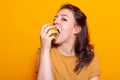 Portrait of healthy woman biting green apple in hand on camera Royalty Free Stock Photo