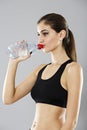 Portrait of a healthy woman with bottle of water. Healthy lifestyle concept. Sporty girl with beautiful body Royalty Free Stock Photo