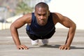 Healthy young black man doing pushups outside