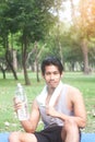 Portrait of healthy young man holding bottle of water in nature Royalty Free Stock Photo