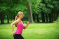 Portrait of a healthy young woman jogging in the park Royalty Free Stock Photo