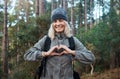 Portrait, heart and happy woman in forest hiking, fitness and health support, self care hands and cardiovascular workout