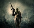 Portrait of a heavily armed masked soldier with grungy background