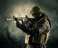 Portrait of a heavily armed masked soldier with grungy background