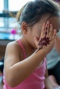 Portrait of Henna ornaments on little girl`s hand covering face Royalty Free Stock Photo