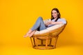 Portrait of her she attractive pretty lovely cheerful cheery girl sitting in comfy wicker chair using device browse