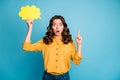 Portrait of her she nice attractive astonished wavy-haired girl holding in hands yellow copy space card pointing up Royalty Free Stock Photo