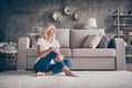 Portrait of her she nice attractive charming cheerful dreamy mature lady sitting on carpet enjoying new house life dream Royalty Free Stock Photo