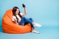 Portrait of her she nice attractive cheerful excited glad wavy-haired girl sitting in chair playing online game win Royalty Free Stock Photo