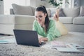 Portrait of her she nice attractive lovely charming focused cheerful brown-haired girl lying on floor using laptop Royalty Free Stock Photo