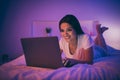 Portrait of her she nice attractive lovely cheerful cheery mature girl lying on bed using laptop chatting with boyfriend Royalty Free Stock Photo