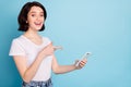 Portrait of her she nice attractive lovely creative cheerful cheery glad girl pointing at cell follow subscribe Royalty Free Stock Photo