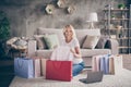 Portrait of her she nice attractive lovely pretty cheerful woman sitting on carpet using laptop opening packing gift