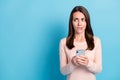 Portrait of her she nice attractive pretty worried brown-haired girl using device looking aside copy space biting lip Royalty Free Stock Photo