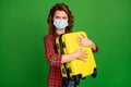 Portrait of her she nice attractive sullen gloomy wavy-haired girl wearing gauze mask embracing valise dangerous tourism